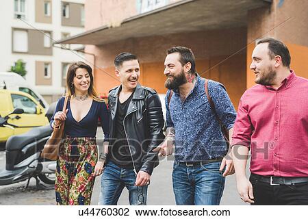 Group of friends walking on sidewalk View Large Photo Image Stock Image - Group of friends walking on sidewalk. Fotosearch