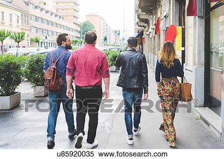 Stock Photography - Group of friends walking on sidewalk. Fotosearch