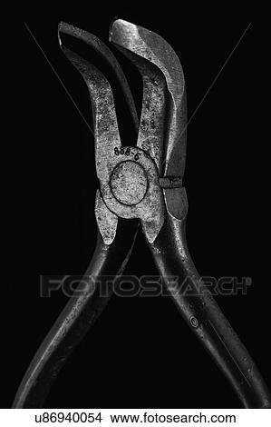 Picture - Hand tool against black background. Fotosearch