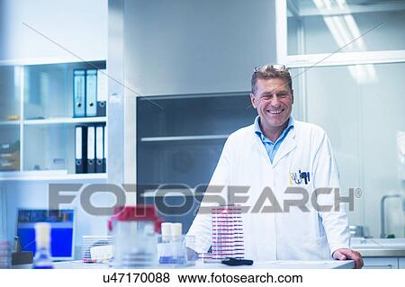 Stock Photo - Happy scientist in laboratory. Fotosearch