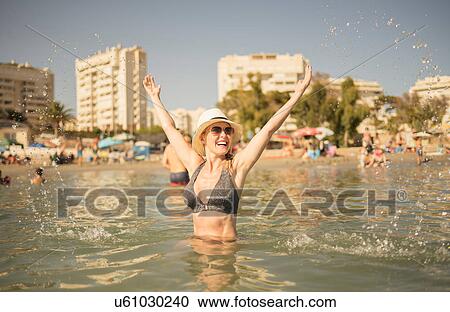 Happy woman splashing in sea, Alicante, Spain View Large Photo Image Stock Image - Happy woman splashing in sea, Alicante, Spain. Fotosearch