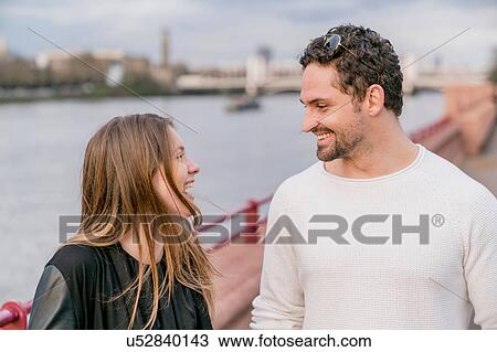 Happy young couple on waterfront, Battersea Park, London, UK View Large Photo Image Stock Image - Happy young couple on waterfront, Battersea Park, London, UK. Fotosearch