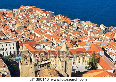 Stock Image - High angle view of Cefalu terracotta rooftops from La Rocca, Sicily, Italy. Fotosearch