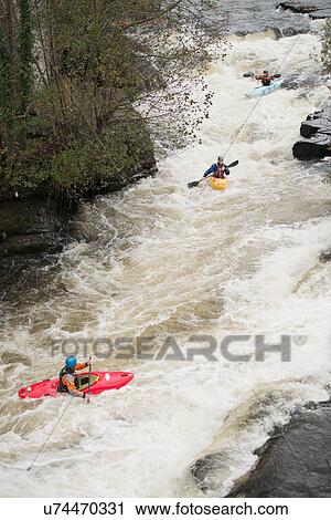 High angle view of kayakers paddling River Dee white water rapids, Llangollen, North Wales View Large Photo Image Stock Image - High angle view of kayakers paddling River Dee white water rapids, Llangollen, North Wales. Fotosearch