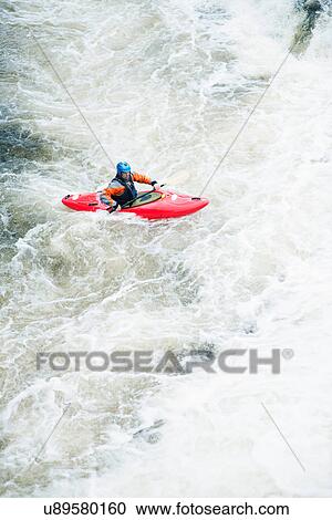 Stock Image - High angle view of male kayaker paddling River Dee white water rapids, Llangollen, North Wales. Fotosearch