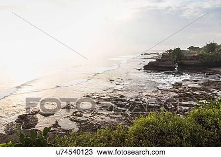 High angle view of sunlit sea, Tanah Lot, Bali, Indonesia View Large Photo Image Stock Image - High angle view of sunlit sea, Tanah Lot, Bali, Indonesia. Fotosearch