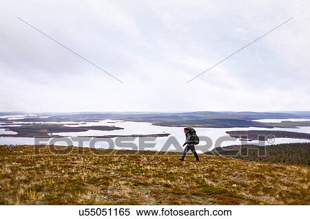 Hiker by lake, Keimiotunturi, Lapland, Finland View Large Photo Image Stock Photography - Hiker by lake, Keimiotunturi, Lapland, Finland. Fotosearch
