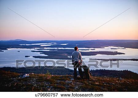 Hiker enjoying sunset at lake, Keimiotunturi, Lapland, Finland View Large Photo Image Stock Photo - Hiker enjoying sunset at lake, Keimiotunturi, Lapland, Finland. Fotosearch
