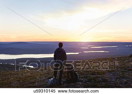 Hiker enjoying sunset at lake, Keimiotunturi, Lapland, Finland View Large Photo Image Stock Photography - Hiker enjoying sunset at lake, Keimiotunturi, Lapland, Finland. Fotosearch