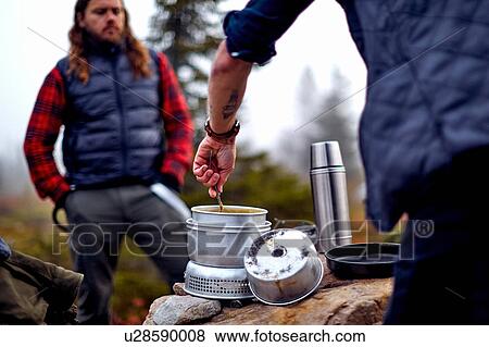Hiker looking at friend cooking, Sarkitunturi, Lapland, Finland View Large Photo Image Stock Photo - Hiker looking at friend cooking, Sarkitunturi, Lapland, Finland. Fotosearch