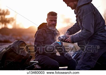 Hiker pouring coffee into friend's cup, Sarkitunturi, Lapland, Finland View Large Photo Image Stock Image - Hiker pouring coffee into friend's cup, Sarkitunturi, Lapland, Finland. Fotosearch