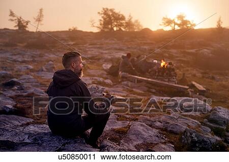 Hiker relaxing with coffee on rocky field, Sarkitunturi, Lapland, Finland View Large Photo Image Stock Image - Hiker relaxing with coffee on rocky field, Sarkitunturi, Lapland, Finland. Fotosearch