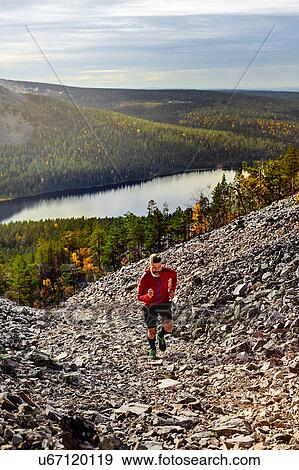 Hiker running up steep hill, Kesankitunturi, Lapland, Finland View Large Photo Image Stock Photo - Hiker running up steep hill, Kesankitunturi, Lapland, Finland. Fotosearch