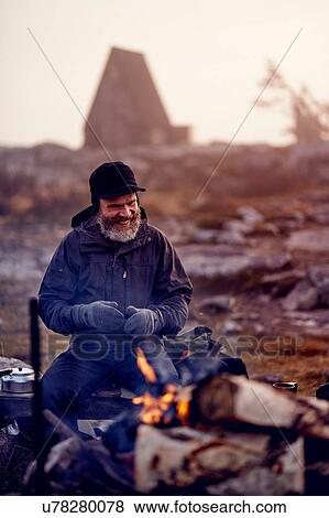 Hiker smiling by campfire, Sarkitunturi, Lapland, Finland View Large Photo Image Stock Photo - Hiker smiling by campfire, Sarkitunturi, Lapland, Finland. Fotosearch