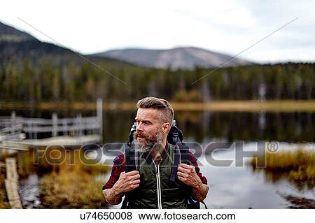 Hiker with lake in background, Kesankijarvi, Lapland, Finland View Large Photo Image Stock Photo - Hiker with lake in background, Kesankijarvi, Lapland, Finland. Fotosearch