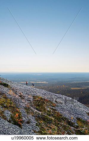 Stock Photography - Hikers ascending rocky steep hill, Kesankitunturi, Lapland, Finland. Fotosearch