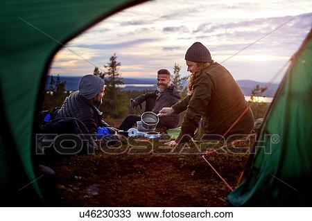 Hikers preparing meal, chatting in front of tent, Keimiotunturi, Lapland, Finland View Large Photo Image Stock Image - Hikers preparing meal, chatting in front of tent, Keimiotunturi, Lapland, Finland. Fotosearch