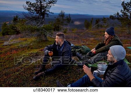 Stock Photo - Hikers relaxing with coffee on hilltop, Keimiotunturi, Lapland, Finland. Fotosearch