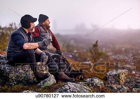 Stock Photo - Hikers relaxing with coffee on rocky field, Sarkitunturi, Lapland, Finland. Fotosearch