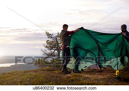 Hikers setting up tent on hilltop, Keimiotunturi, Lapland, Finland View Large Photo Image Stock Image - Hikers setting up tent on hilltop, Keimiotunturi, Lapland, Finland. Fotosearch