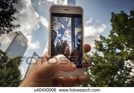 Stock Photograph - Iconic buildings, World Trade Centre on screen of cellphone, New York, USA. Fotosearch