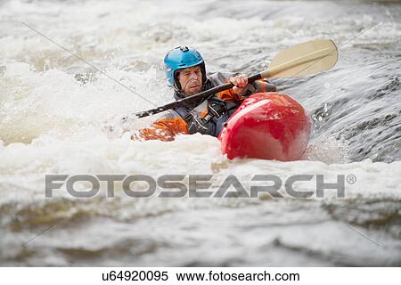 Stock Photography - Imbalanced male kayaker paddling River Dee rapids. Fotosearch