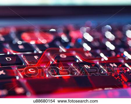 Picture - In camera double exposure of the surface of a laptop and the hardware electronics of the computer underneath. Fotosearch