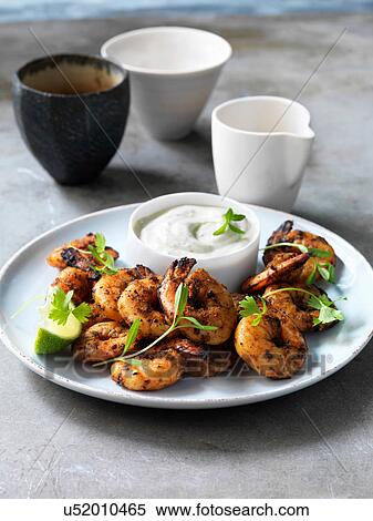Stock Photography - Indonesian jumbo peeled king prawns, fresh lime and coriander. Fotosearch