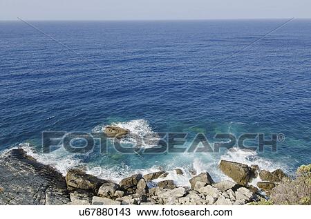 Stock Image - Italy, Liguria, Sestri Levante, Stones by sea. Fotosearch