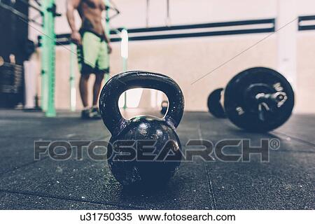 Kettlebell and barbell on floor of cross training gym View Large Photo Image Stock Photography - Kettlebell and barbell on floor of cross training gym. Fotosearch