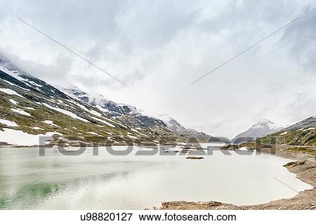Stock Photo - Lago Bianco (White Lake) and snow capped mountain view, Grisons (Graubnden), Switzerland. Fotosearch