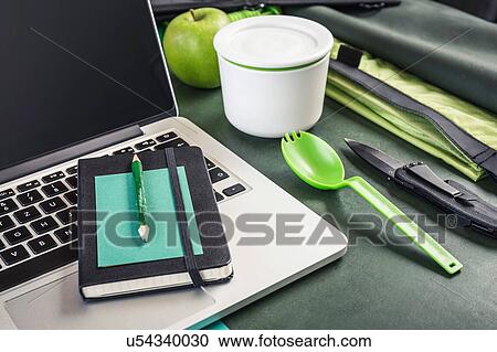 Stock Image - Laptop, notebook and pocket knife on table. Fotosearch