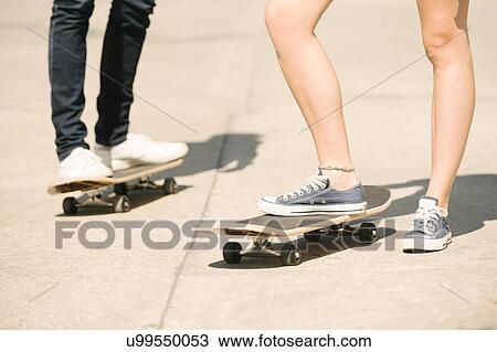 Legs of female and male skateboarders standing in skatepark View Large Photo Image Stock Image - Legs of female and male skateboarders standing in skatepark. Fotosearch