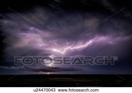 Stock Image - Lightning sparks from a spinning supercell thunderstorm at night near Leoti, Kansas. Fotosearch