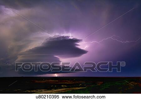 Stock Photography - Lightning sparks from a spinning supercell thunderstorm at night near Leoti, Kansas. Fotosearch