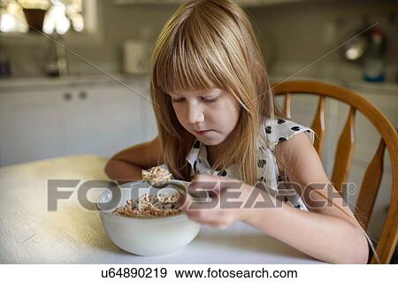 Stock Photo - Little girl eating breakfast. Fotosearch