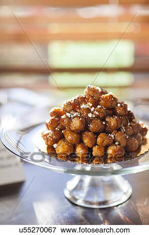Stock Photo - Loukoumades, greek dessert on platter. Fotosearch