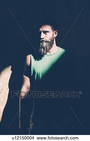 Low key portrait of young man staring from shadows View Large Photo Image Picture - Low key portrait of young man staring from shadows. Fotosearch