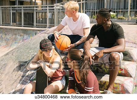Male and female basketball friends chatting in city skatepark View Large Photo Image Stock Photo - Male and female basketball friends chatting in city skatepark. Fotosearch