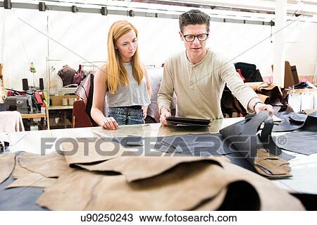Male and female colleagues working together in leather jacket manufacturers View Large Photo Image Stock Image - Male and female colleagues working together in leather jacket manufacturers. Fotosearch