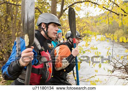 Male and female kayakers looking out from river bank, River Dee, Llangollen, North Wales View Large Photo Image Picture - Male and female kayakers looking out from river bank, River Dee, Llangollen, North Wales. Fotosearch