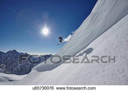 Male freestyle skier jumping mid air from mountainside, Zugspitze, Bayern, Germany View Large Photo Image Stock Photograph - Male freestyle skier jumping mid air from mountainside, Zugspitze, Bayern, Germany. Fotosearch
