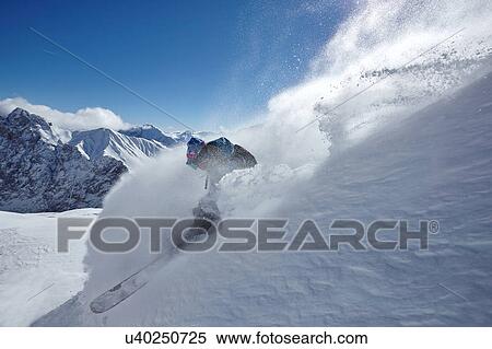 Male freestyle skier skiing down snow powdered mountainside, Zugspitze, Bayern, Germany View Large Photo Image Stock Photography - Male freestyle skier skiing down snow powdered mountainside, Zugspitze, Bayern, Germany. Fotosearch