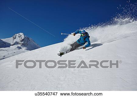 Male freestyle skier skiing down mountainside, Zugspitze, Bayern, Germany View Large Photo Image Stock Photo - Male freestyle skier skiing down mountainside, Zugspitze, Bayern, Germany. Fotosearch