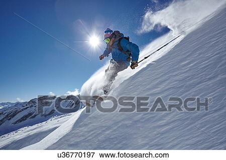 Male freestyle skier skiing down mountainside, Zugspitze, Bayern, Germany View Large Photo Image Stock Photo - Male freestyle skier skiing down mountainside, Zugspitze, Bayern, Germany. Fotosearch