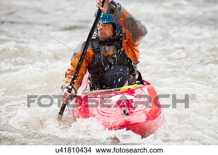 Male kayaker paddling River Dee rapids View Large Photo Image Picture - Male kayaker paddling River Dee rapids. Fotosearch