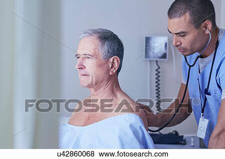 Male nurse listening to senior male patient back with stethoscope View Large Photo Image Stock Photo - Male nurse listening to senior male patient back with stethoscope. Fotosearch
