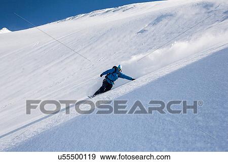 Male snowboarder snowboarding down steep mountain, Trient, Swiss Alps, Switzerland View Large Photo Image Stock Photo - Male snowboarder snowboarding down steep mountain, Trient, Swiss Alps, Switzerland. Fotosearch