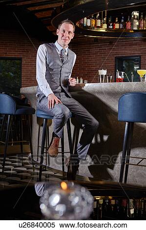 Stock Photography - Man at bar looking at camera smiling. Fotosearch