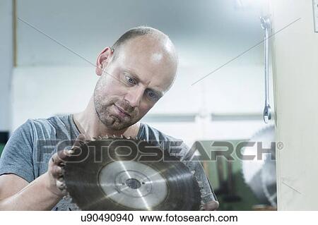 Man checking rotary blade on grinding machine View Large Photo Image Stock Image - Man checking rotary blade on grinding machine. Fotosearch